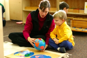 teacher and student with maps work